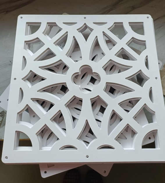 White decorative perforated panel with geometric cutouts stack